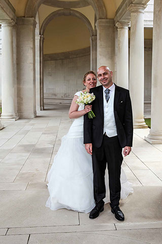 COUPLE DE MARIES DEBOUT FACE A L'OBJECTIF DANS UN MAUSAULE